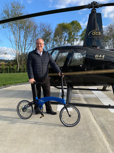 Customer with custom bike next to helicopter